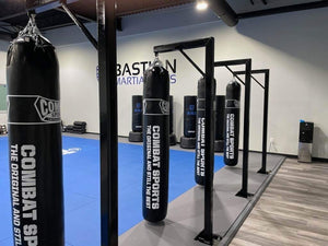 A MMA gym with punching bags and racks